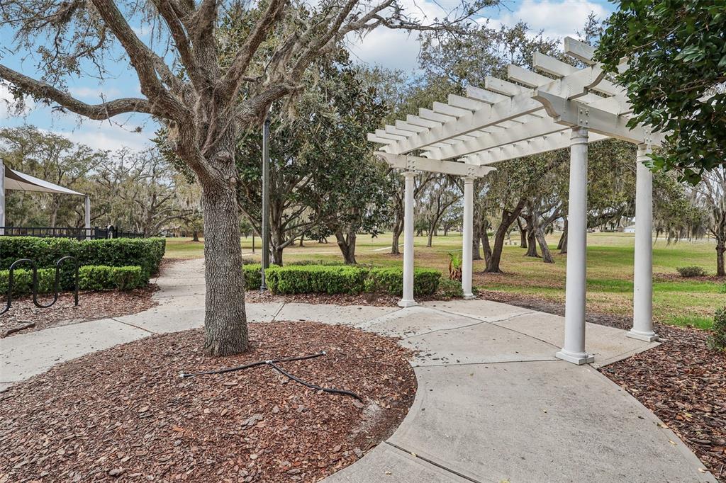2104 Congress Lane St. Cloud, FL 34769 - Photo 52 of 71 a patio with a table and chairs under an large tree
