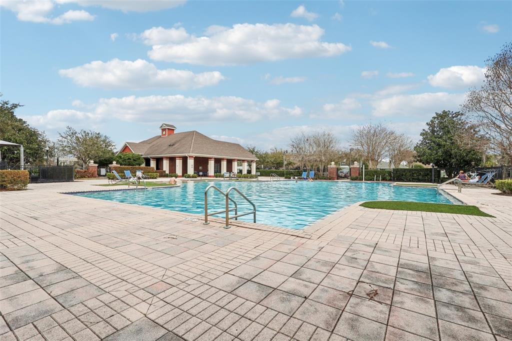 2104 Congress Lane St. Cloud, FL 34769 - Photo 54 of 71 a view of swimming pool with seating space and trees in the background