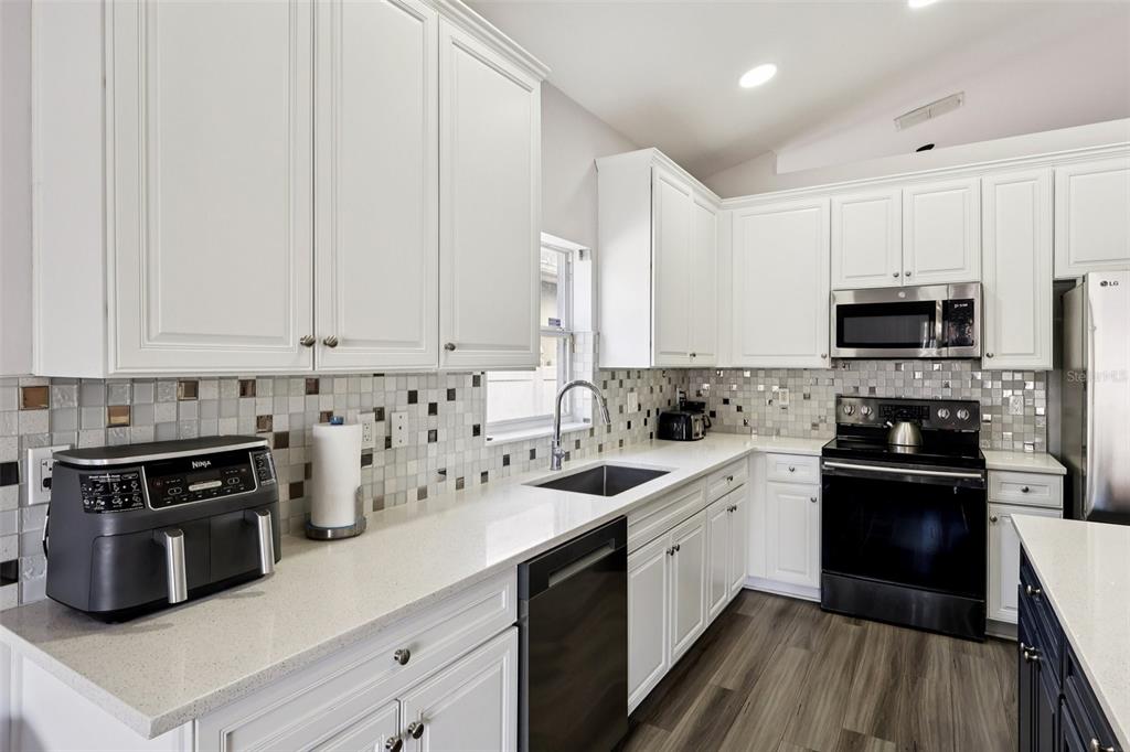 2104 Congress Lane St. Cloud, FL 34769 - Photo 10 of 71 a kitchen with a sink stove and cabinets