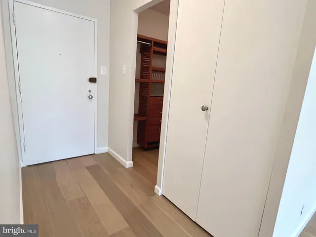 a view of a hallway with wooden floor