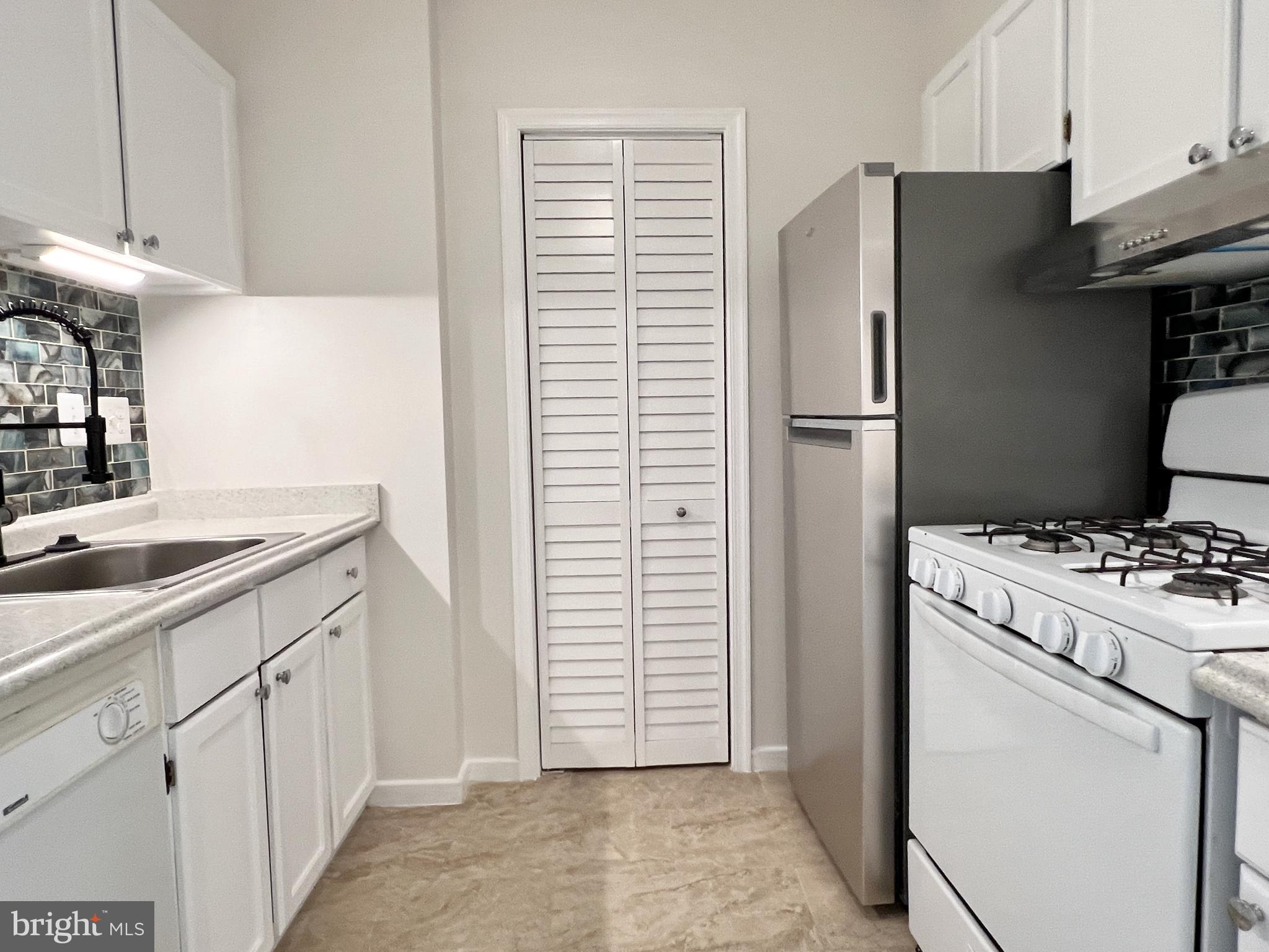 430 M Street Southwest, Unit N203 Washington, DC 20024 - Photo 4 of 5 a kitchen with a refrigerator sink and stove
