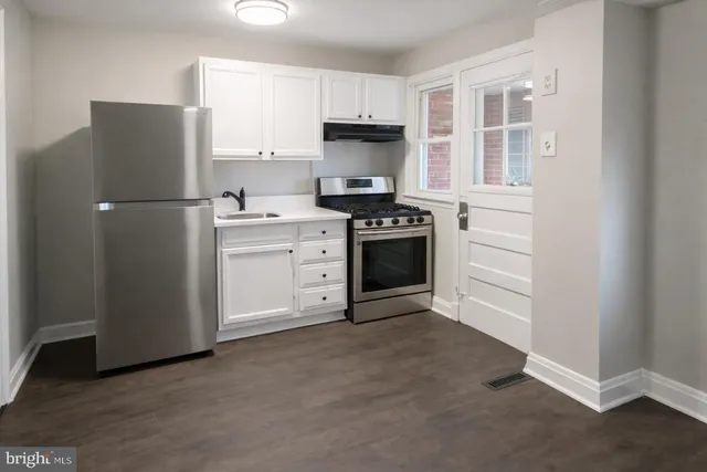 a kitchen with stainless steel appliances granite countertop a refrigerator stove and sink