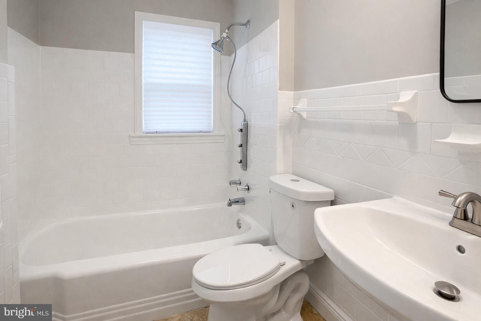 3582 Dudley Avenue Baltimore, MD 21213 - Photo 6 of 12 a bathroom with a sink toilet and shower