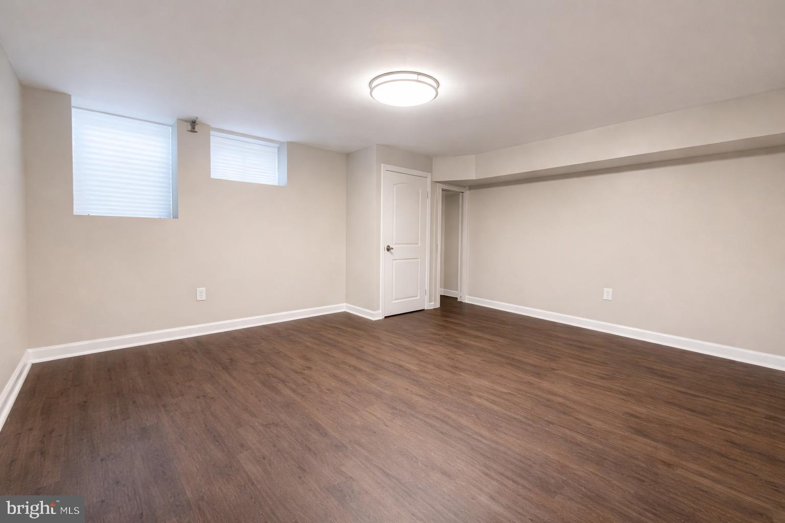 3582 Dudley Avenue Baltimore, MD 21213 - Photo 9 of 12 a view of an empty room with wooden floor and a window
