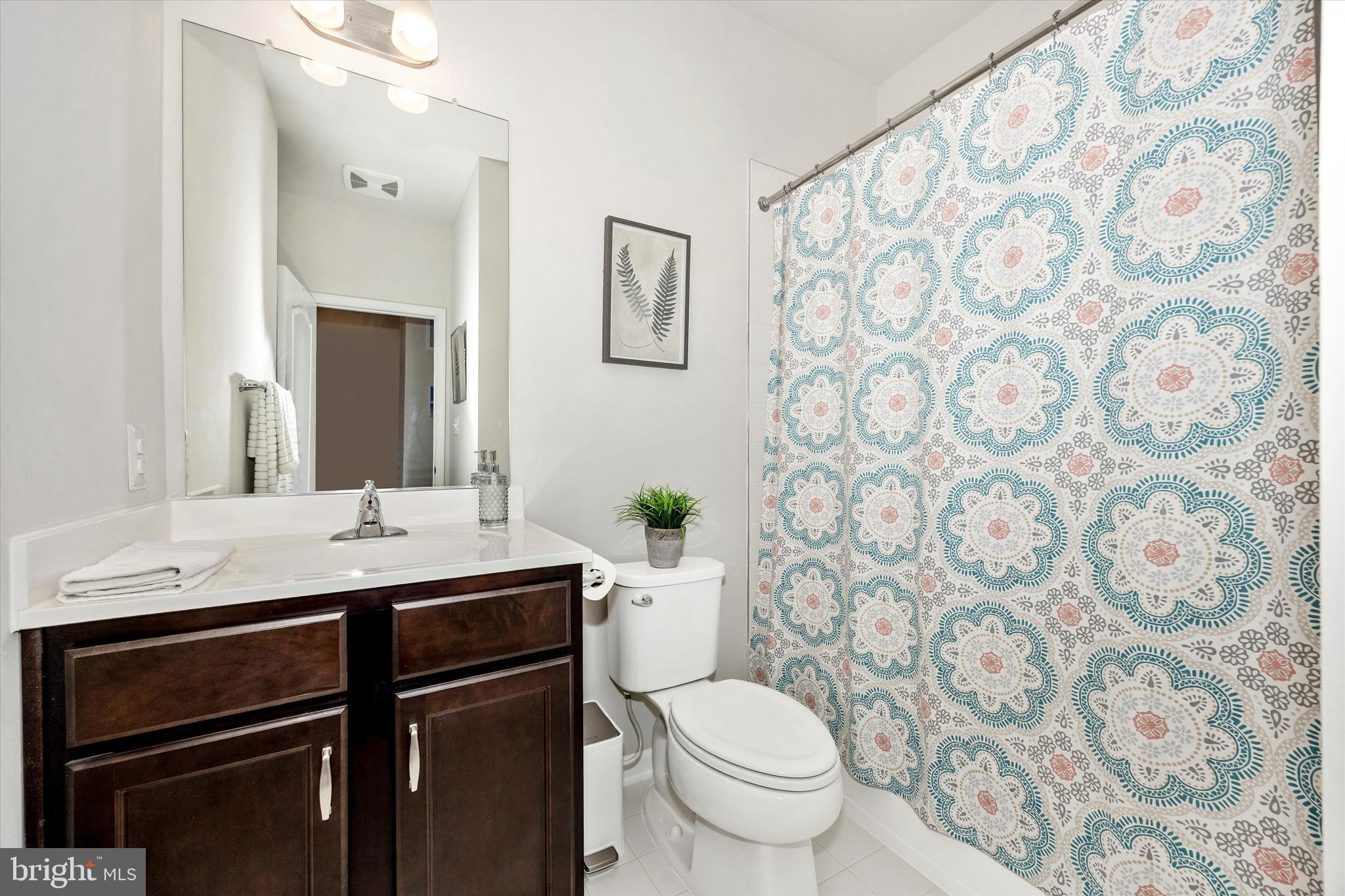 1817 Bird Run Frederick, MD 21702 - Photo 20 of 31 a bathroom with a granite countertop sink toilet and mirror