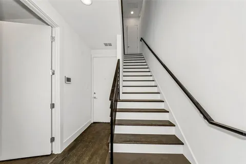 a view of entryway with wooden floor and stairs