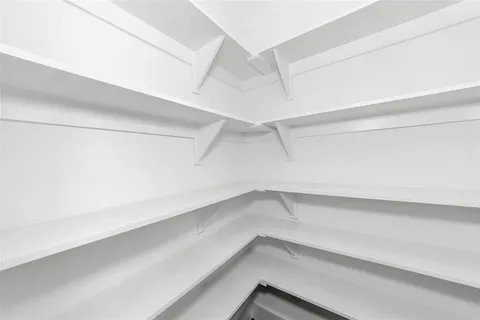 a kitchen with a refrigerator a stove top oven a sink and a window