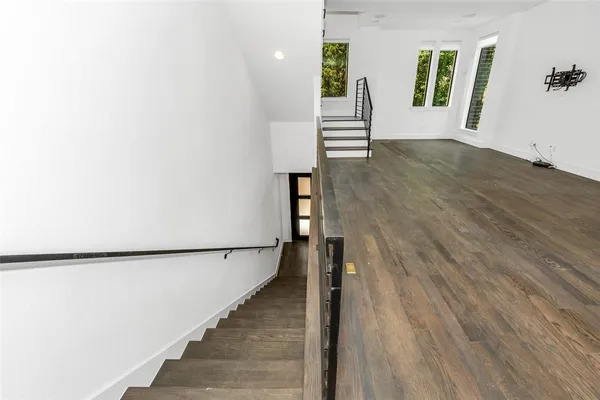 a view of an entryway with wooden floor