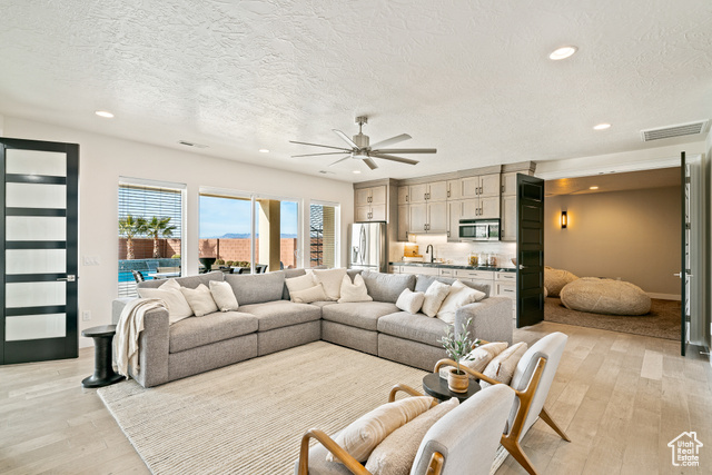 6026 Zen Trail Way St. George, UT 84790 - Photo 20 of 41 Living room featuring recessed lighting, light wood-style floors, a textured ceiling, and a ceiling fan