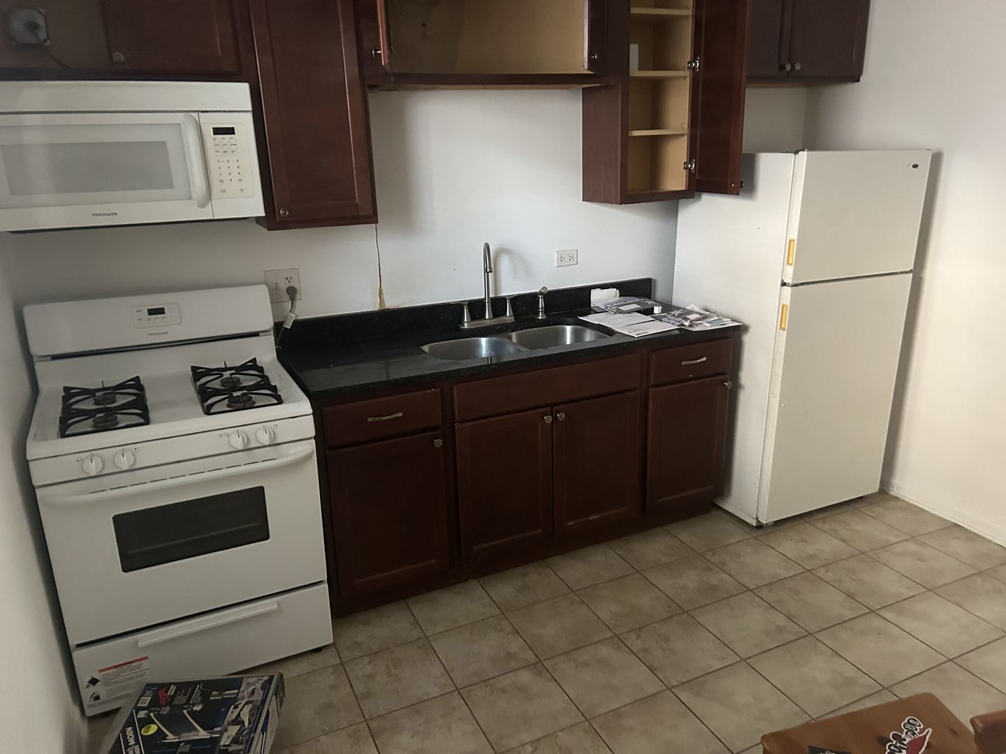 1106 West Polk Street Chicago, IL 60607 - Photo 4 of 13 a kitchen with a cabinets stove and refrigerator