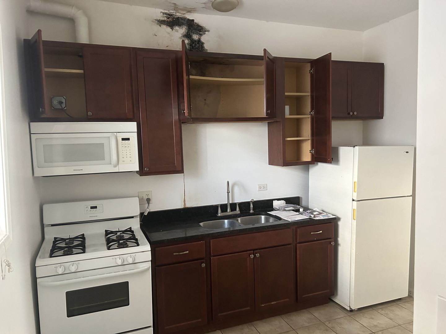 1106 West Polk Street Chicago, IL 60607 - Photo 7 of 13 a kitchen with stainless steel appliances a stove a microwave and a refrigerator