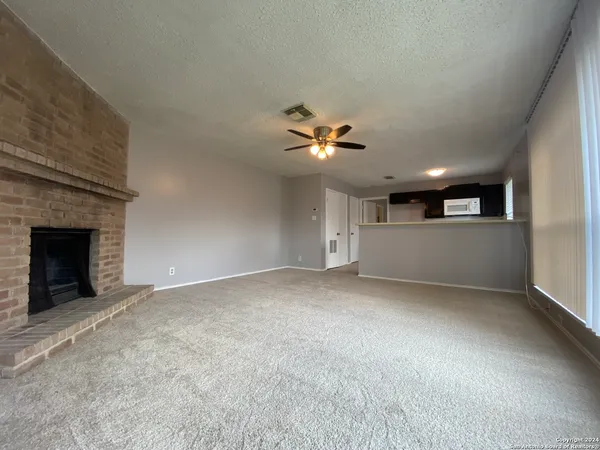 a view of an empty room with a fireplace