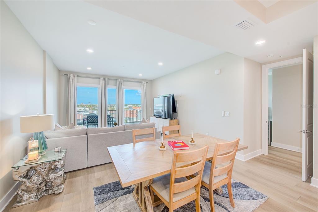 400 150th Avenue, Unit 504 Madeira Beach, FL 33708 - Photo 19 of 60 a view of a dining room with furniture and wooden floor