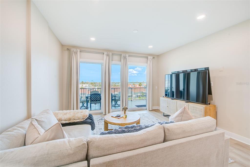 400 150th Avenue, Unit 504 Madeira Beach, FL 33708 - Photo 21 of 60 a living room with furniture and large windows