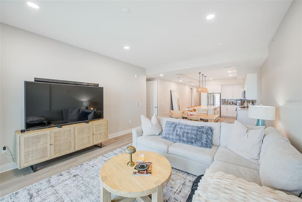 400 150th Avenue, Unit 504 Madeira Beach, FL 33708 - Photo 22 of 60 a living room with furniture and a flat screen tv