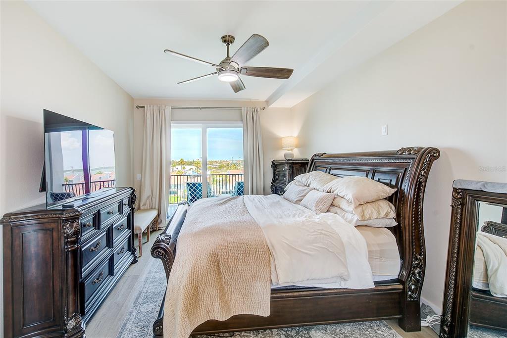 400 150th Avenue, Unit 504 Madeira Beach, FL 33708 - Photo 35 of 60 a bedroom with a bed and wooden floor