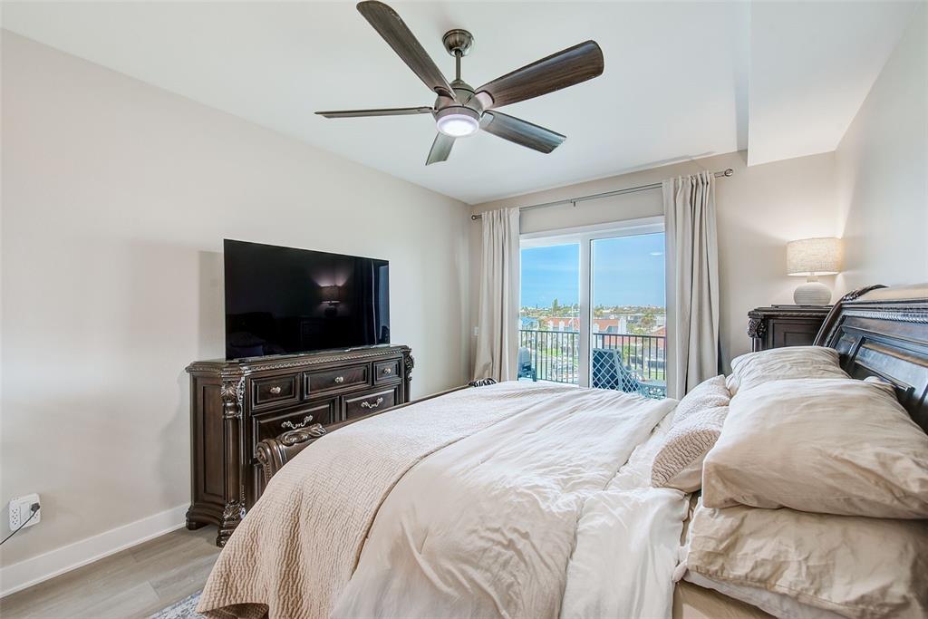 400 150th Avenue, Unit 504 Madeira Beach, FL 33708 - Photo 36 of 60 a bedroom with a bed and a flat screen tv
