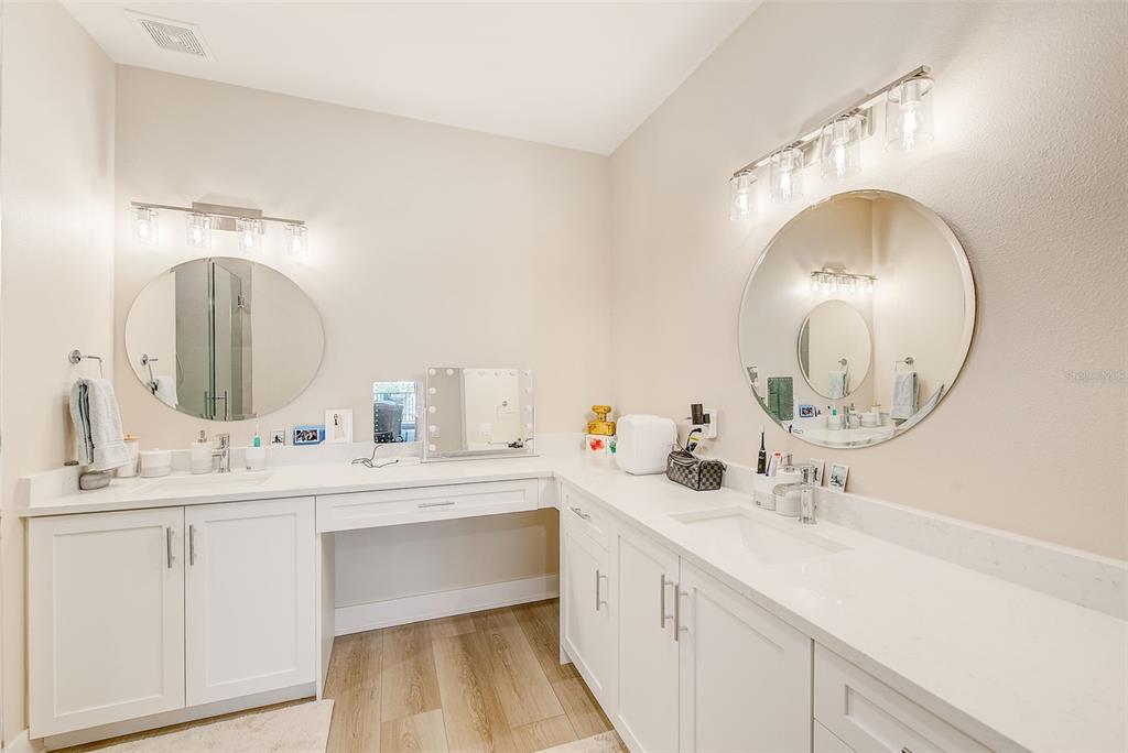 400 150th Avenue, Unit 504 Madeira Beach, FL 33708 - Photo 39 of 60 a bathroom with a double vanity sink and a mirror