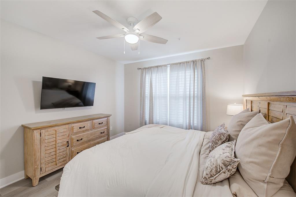 400 150th Avenue, Unit 504 Madeira Beach, FL 33708 - Photo 44 of 60 a bedroom with a large bed and a flat screen tv