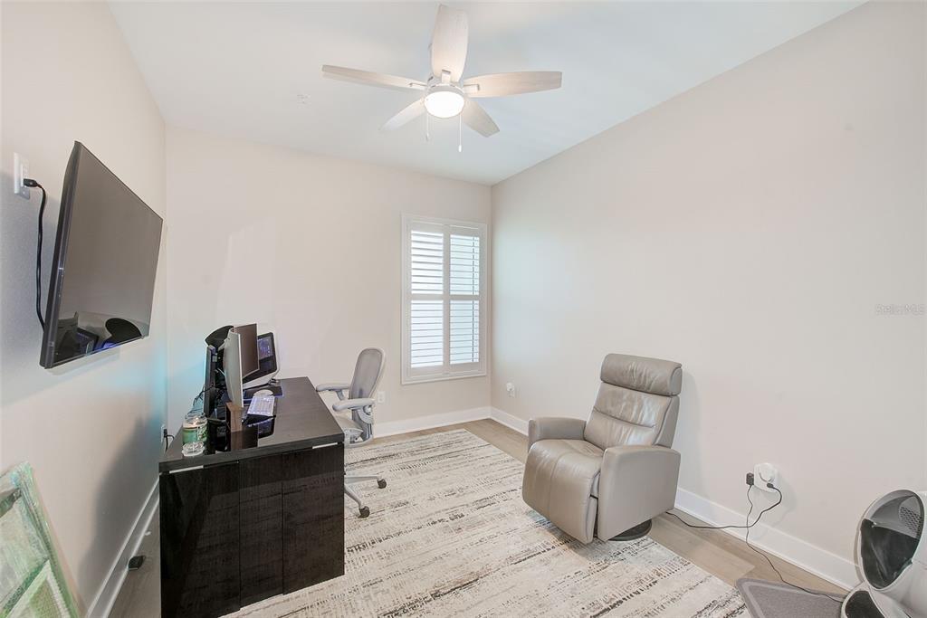 400 150th Avenue, Unit 504 Madeira Beach, FL 33708 - Photo 46 of 60 a living room with furniture a flat screen tv and window