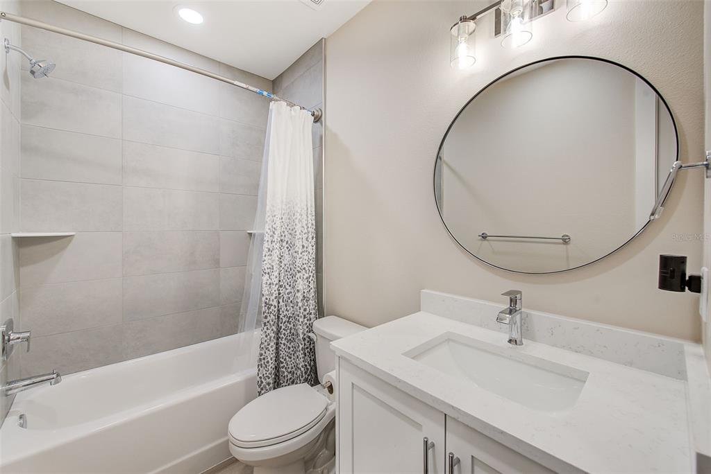 400 150th Avenue, Unit 504 Madeira Beach, FL 33708 - Photo 48 of 60 a bathroom with a sink a toilet and a mirror