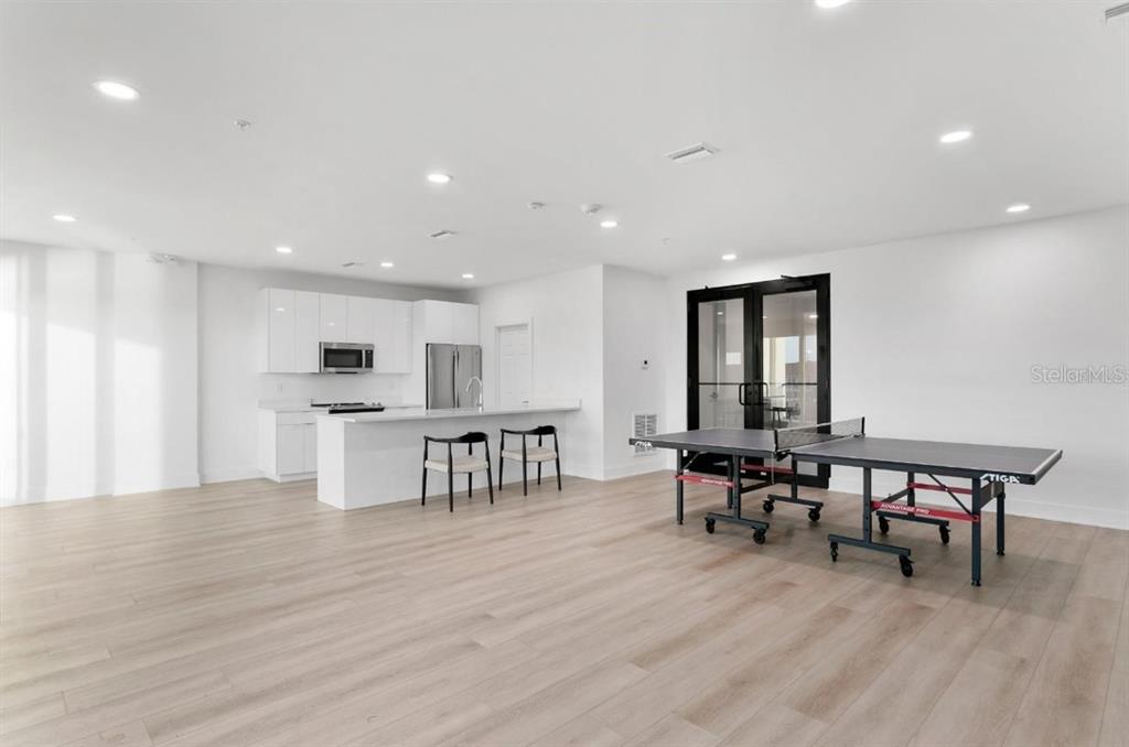 400 150th Avenue, Unit 504 Madeira Beach, FL 33708 - Photo 56 of 60 a view of a kitchen with dining room and wooden floor