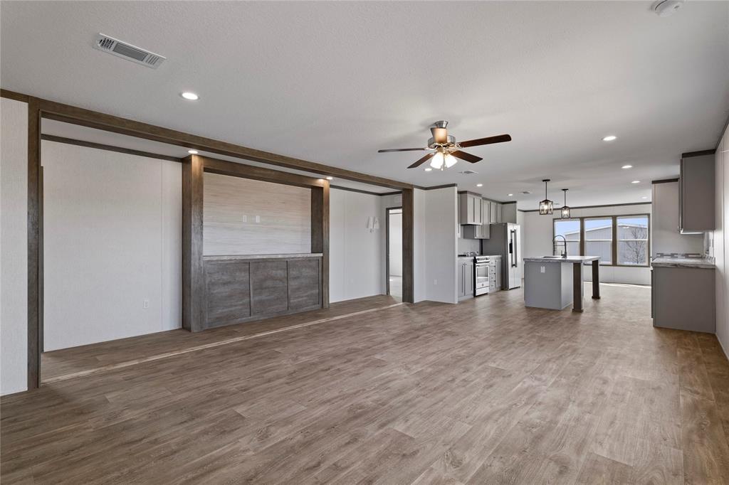 3888 Sandusky Road Whitesboro, TX 76273 - Photo 7 of 24 Unfurnished living room featuring dark wood-style flooring, ceiling fan, and recessed lighting