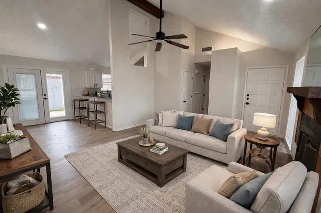 a living room with furniture and a wooden floor