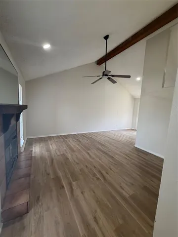 a view of a room with wooden floor