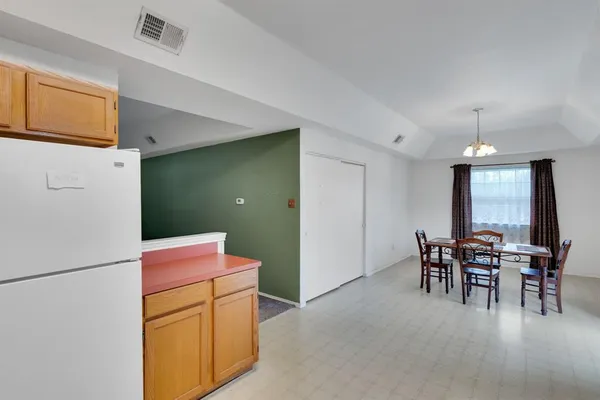 a dining room with furniture and chandelier