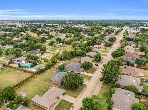 an aerial view of residential houses with outdoor space