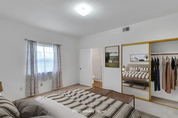 a bedroom with a large bed and a window