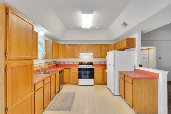a kitchen with a stove a refrigerator and a sink