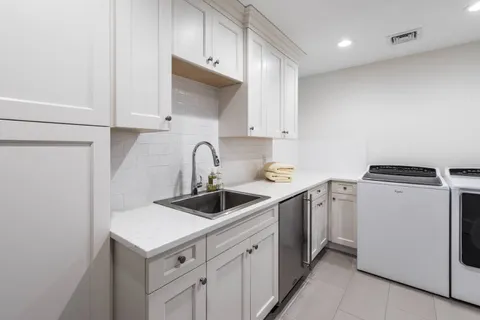 a kitchen with appliances a sink and cabinets