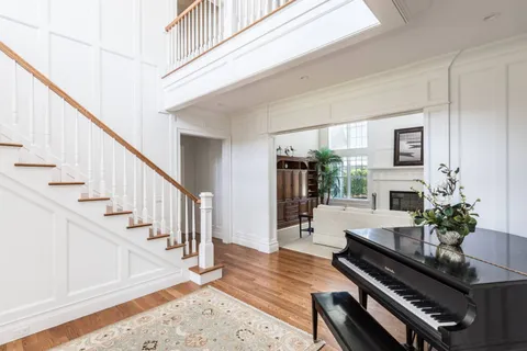 a living room with furniture fireplace and dining room
