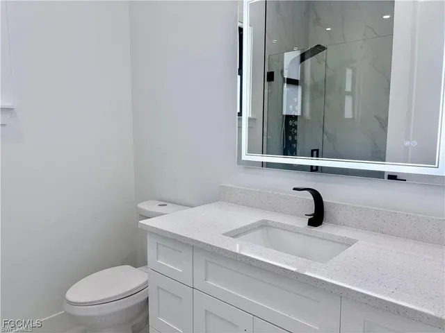 a bathroom with a shower and a glass door