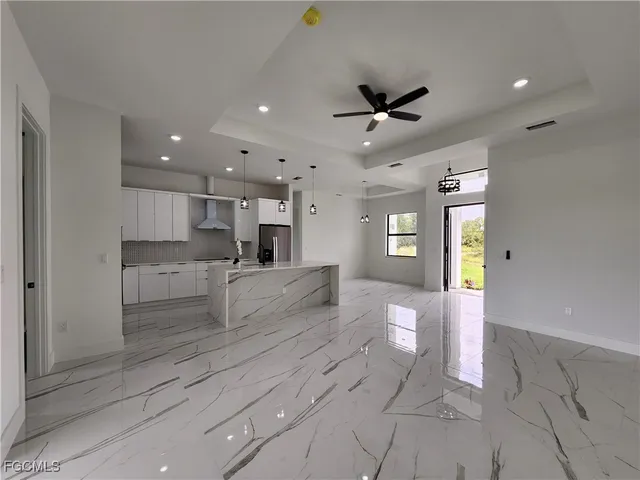 a kitchen with kitchen island a sink a counter and stainless steel appliances