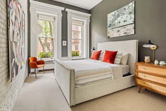 a spacious bedroom with a bed and a large window