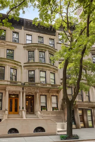 a front view of a residential apartment building with a yard