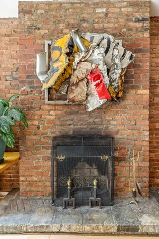 a patio with table and chairs and potted plants