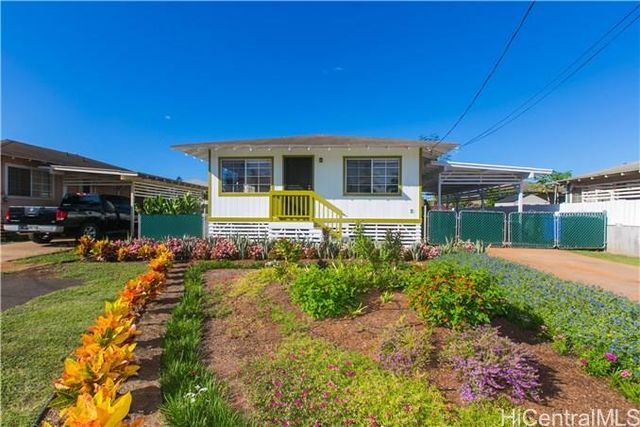 a view of a house with backyard sitting area and swimming pool
