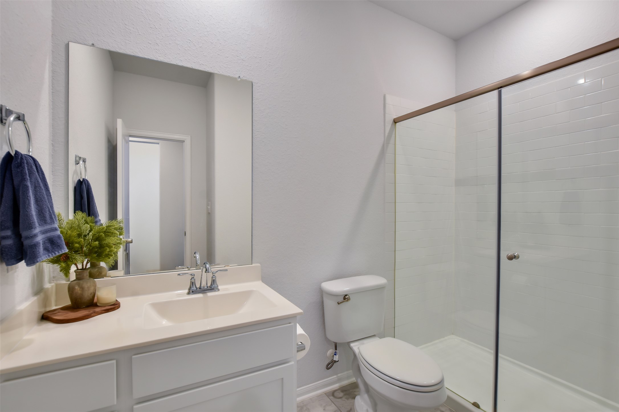 605 Oleander Loop Buda, TX 78610 - Photo 21 of 32 a bathroom with a sink a toilet a mirror and shower