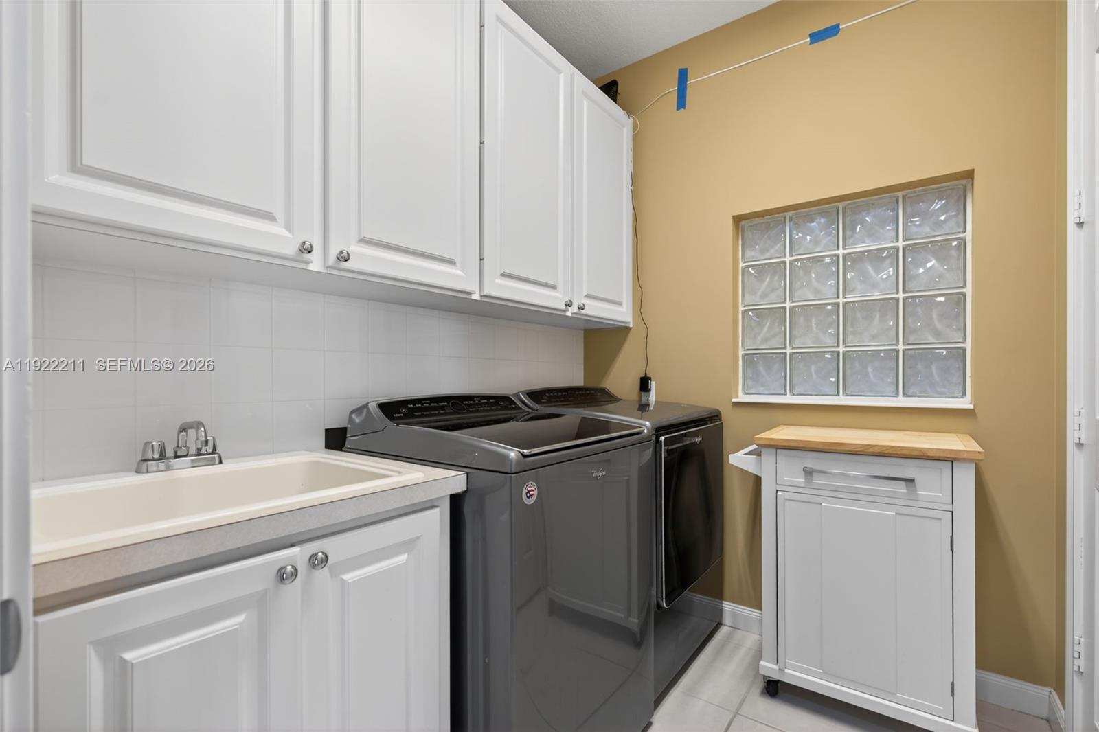 3518 Community Drive Jupiter, FL 33458 - Photo 14 of 38 a utility room with sink dryer and washer