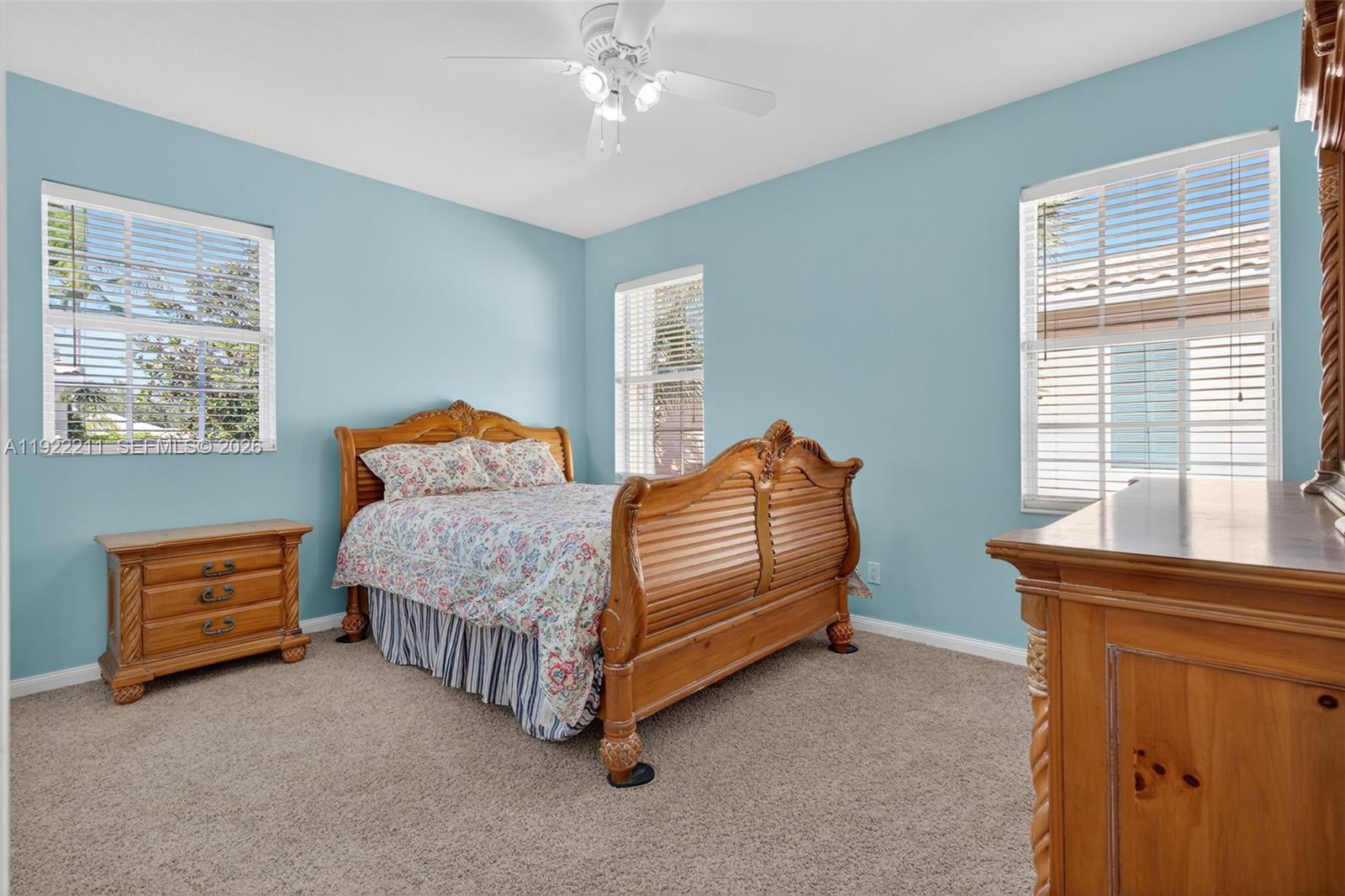 3518 Community Drive Jupiter, FL 33458 - Photo 22 of 38 a bedroom with a bed and a window