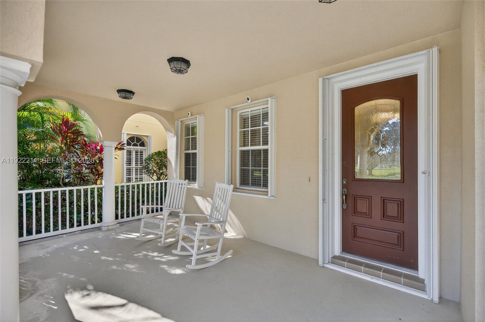 3518 Community Drive Jupiter, FL 33458 - Photo 3 of 38 a view of a dining room with a large window and wooden floor