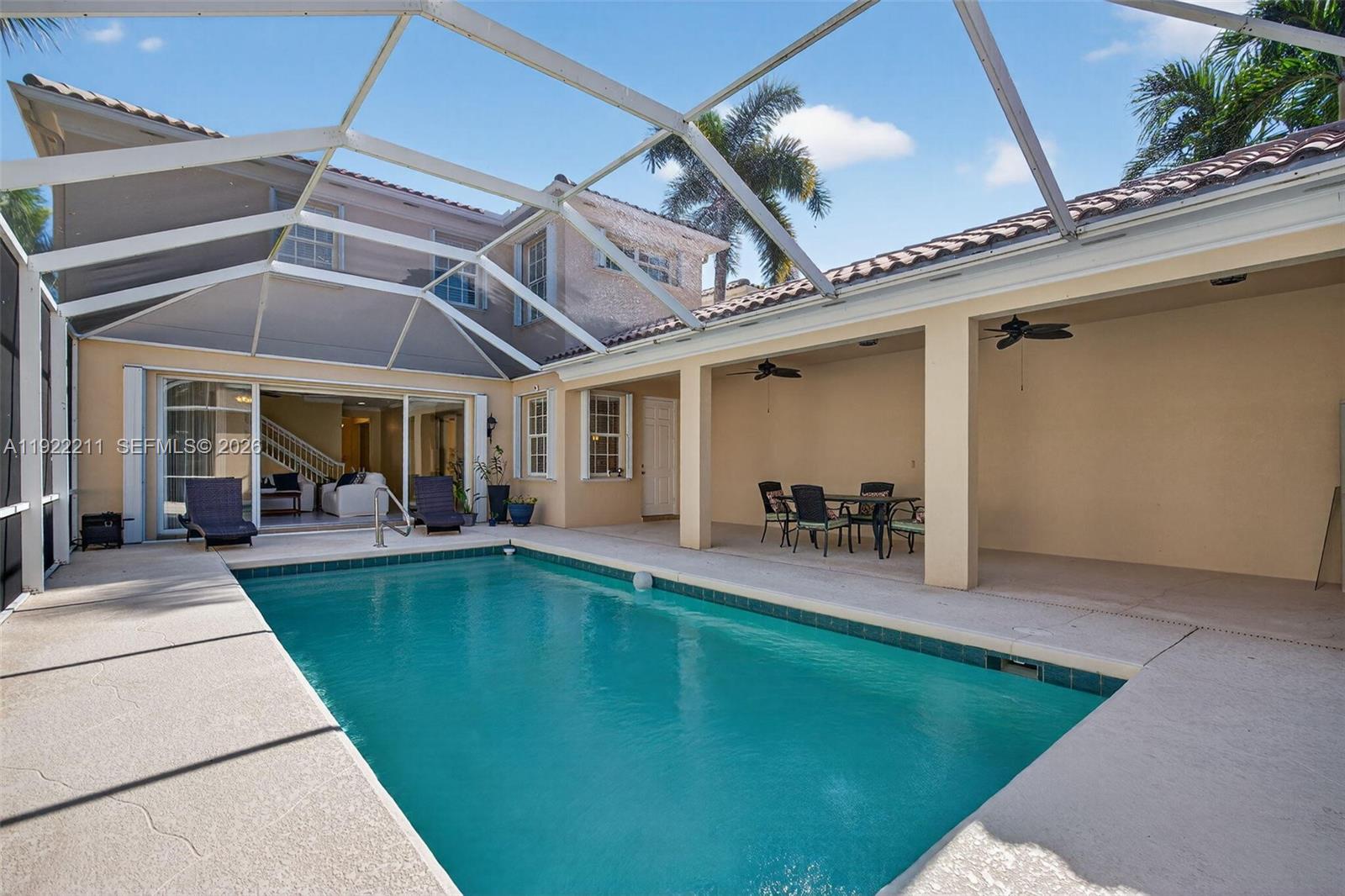 3518 Community Drive Jupiter, FL 33458 - Photo 33 of 38 a view of a backyard with a swimming pool table and chairs