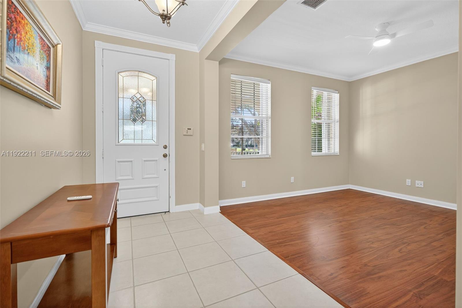 3518 Community Drive Jupiter, FL 33458 - Photo 5 of 38 wooden floor in an empty room with a window