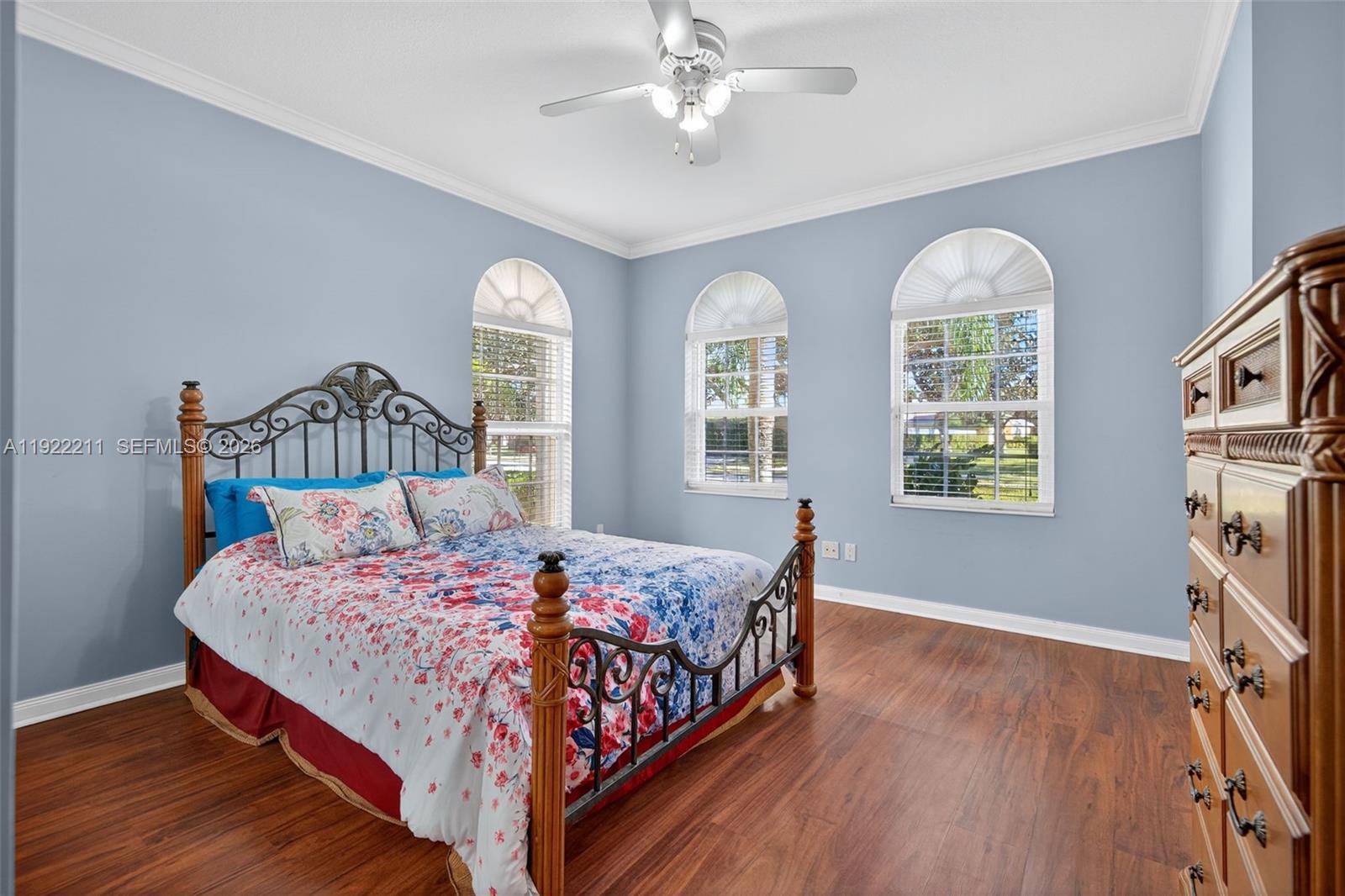 3518 Community Drive Jupiter, FL 33458 - Photo 7 of 38 a bedroom with a bed mirror and window