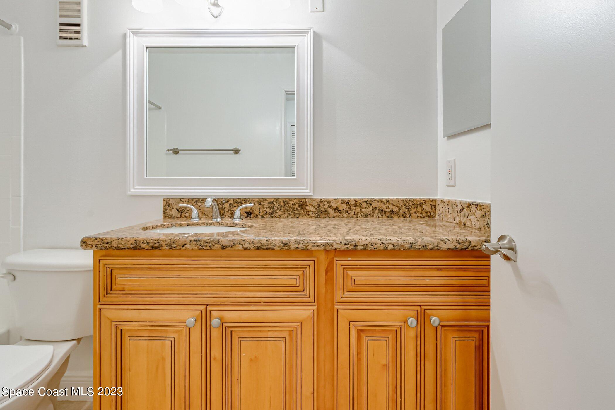 7667 North Wickham Road, Unit 617 Melbourne, FL 32940 - Photo 13 of 44 a bathroom with a sink and a mirror