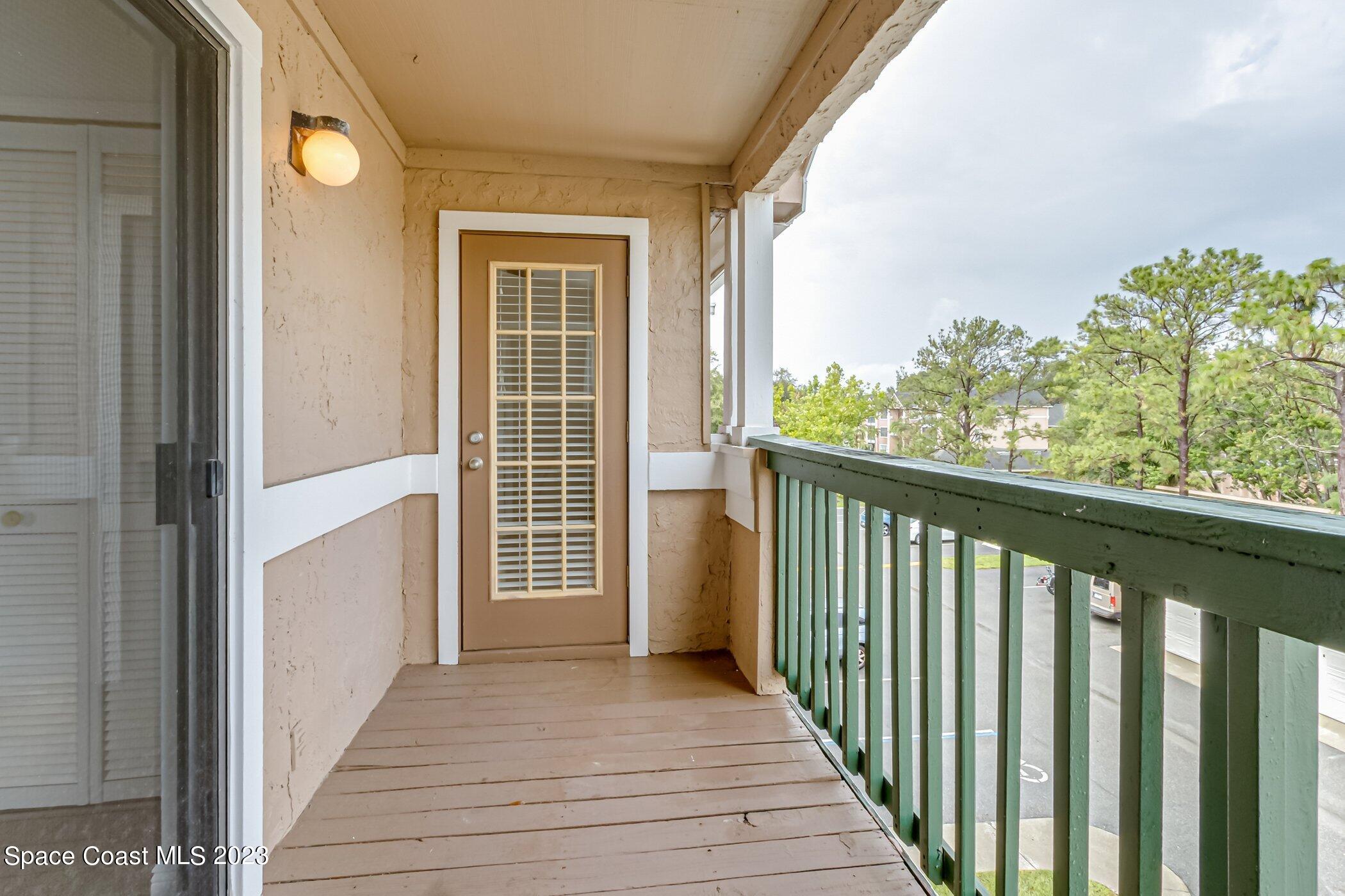7667 North Wickham Road, Unit 617 Melbourne, FL 32940 - Photo 23 of 44 a view of a balcony with wooden floor